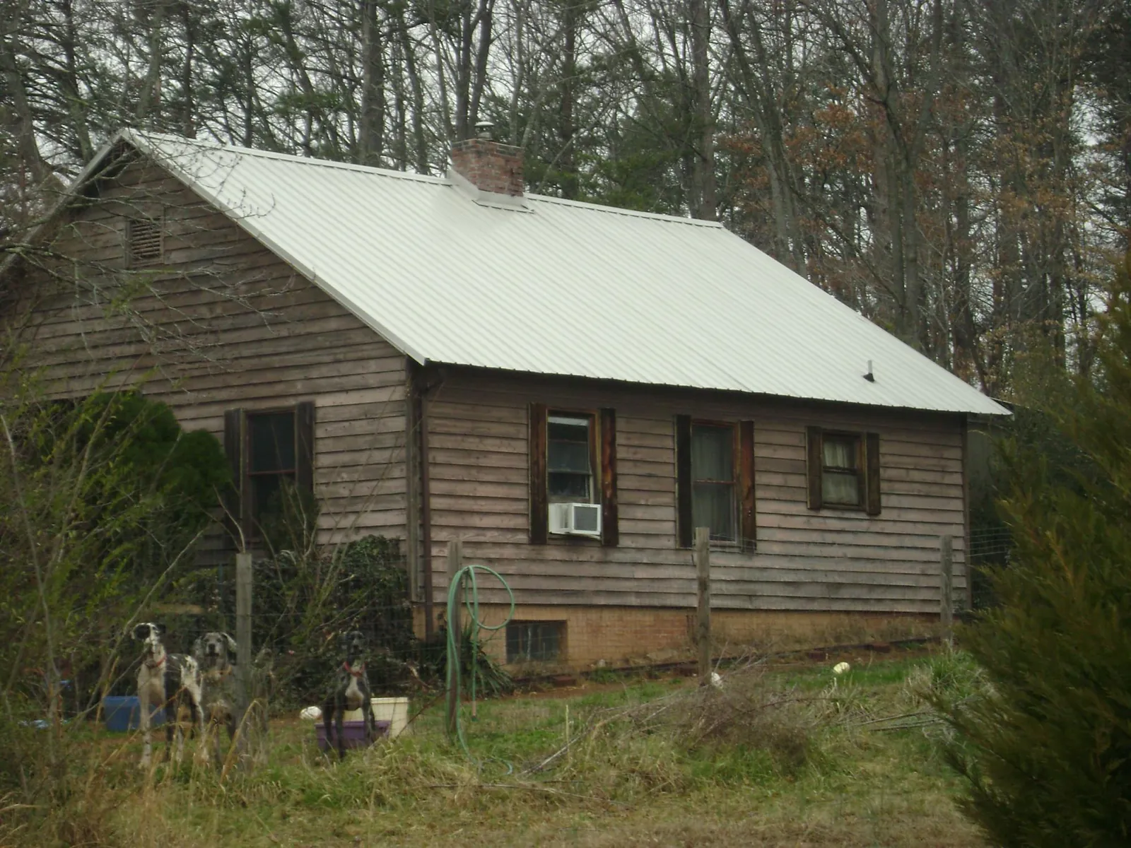 White metal roof on an old wood sided farmhouse, from a Metal Roof Installation job in Harvard